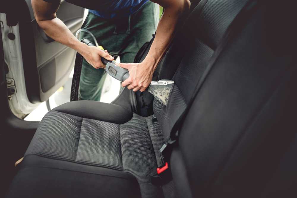 Car care concept, detailing and cleaning of interior back seats at luxury modern cars